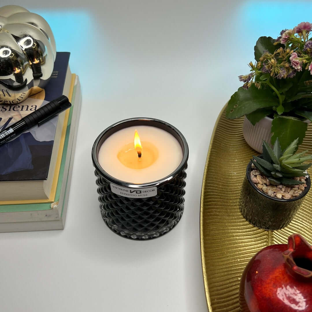 Candle burning beside a home decor and a book